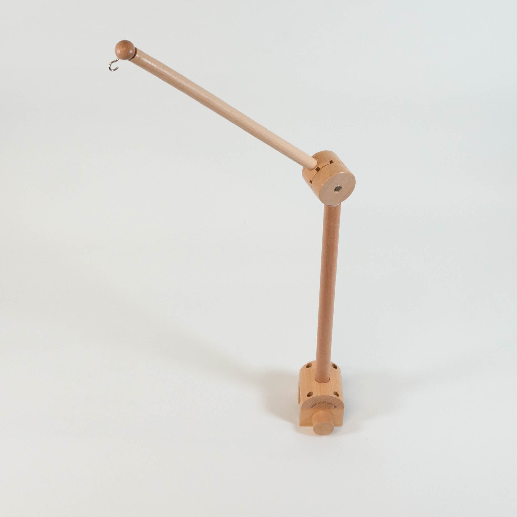 A wooden mobile arm standing up and extended on a white background.