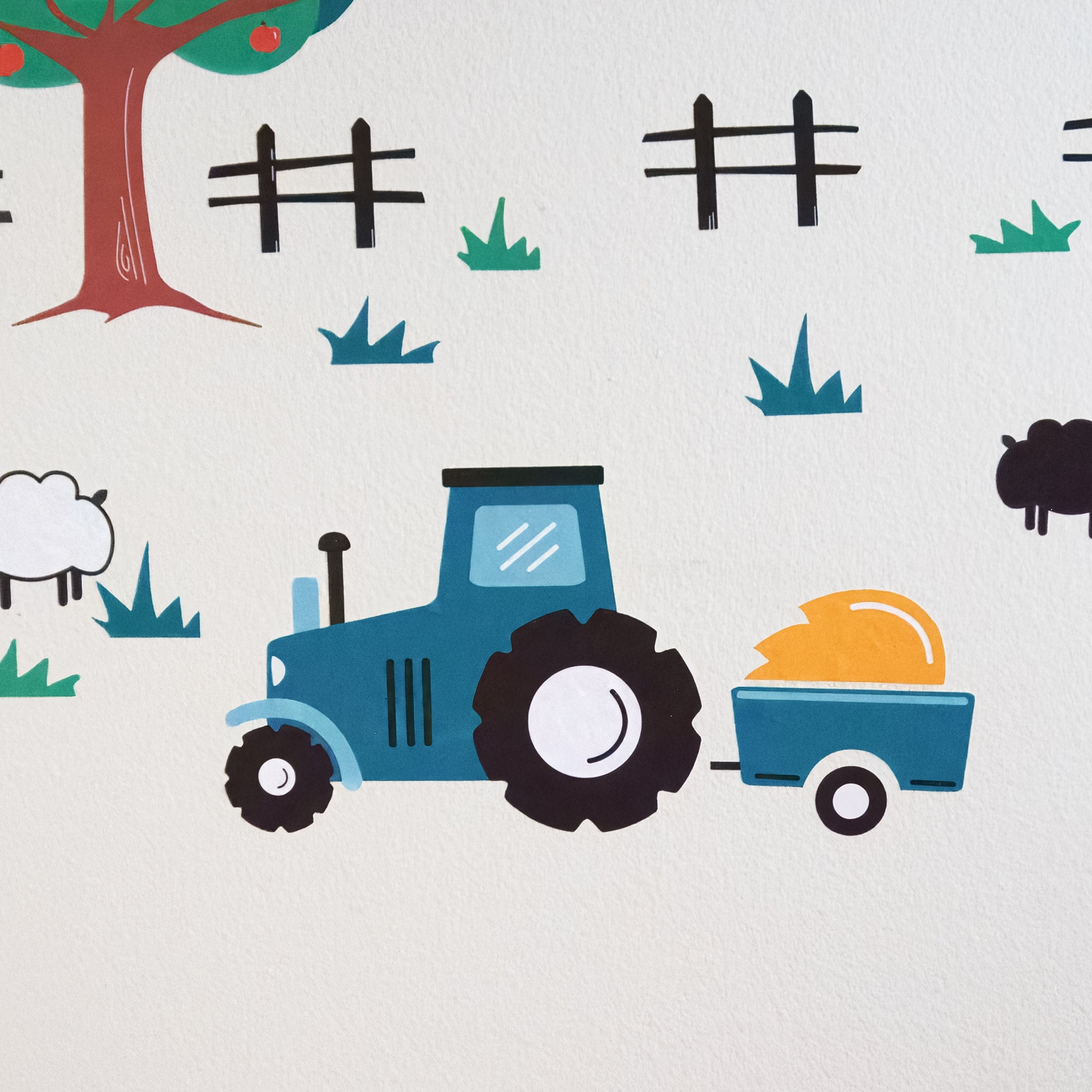 A farm tractor wall decal in teal on a white wall pulling a wagon of yellow hay.