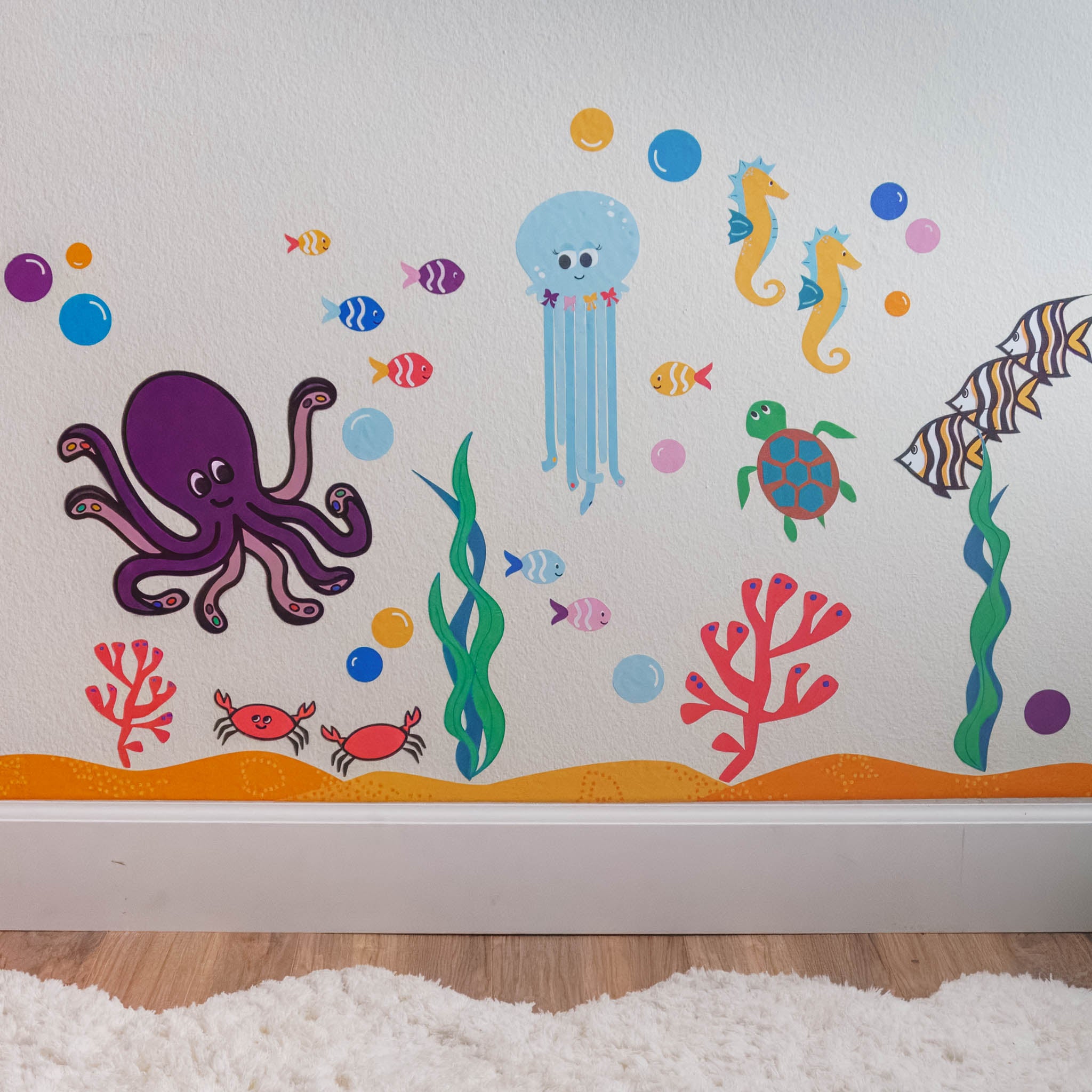 A colorful ocean mural on a white wall made with wall stickers.