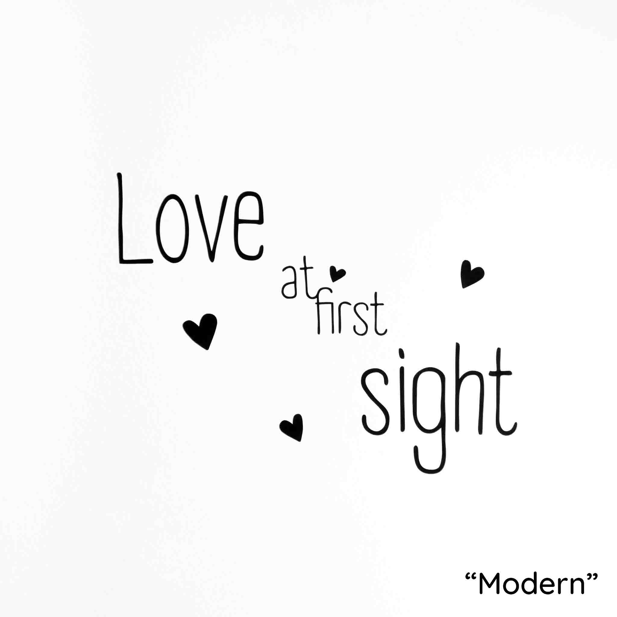 White background with "love at first sight" written in black, modern font with black hearts.